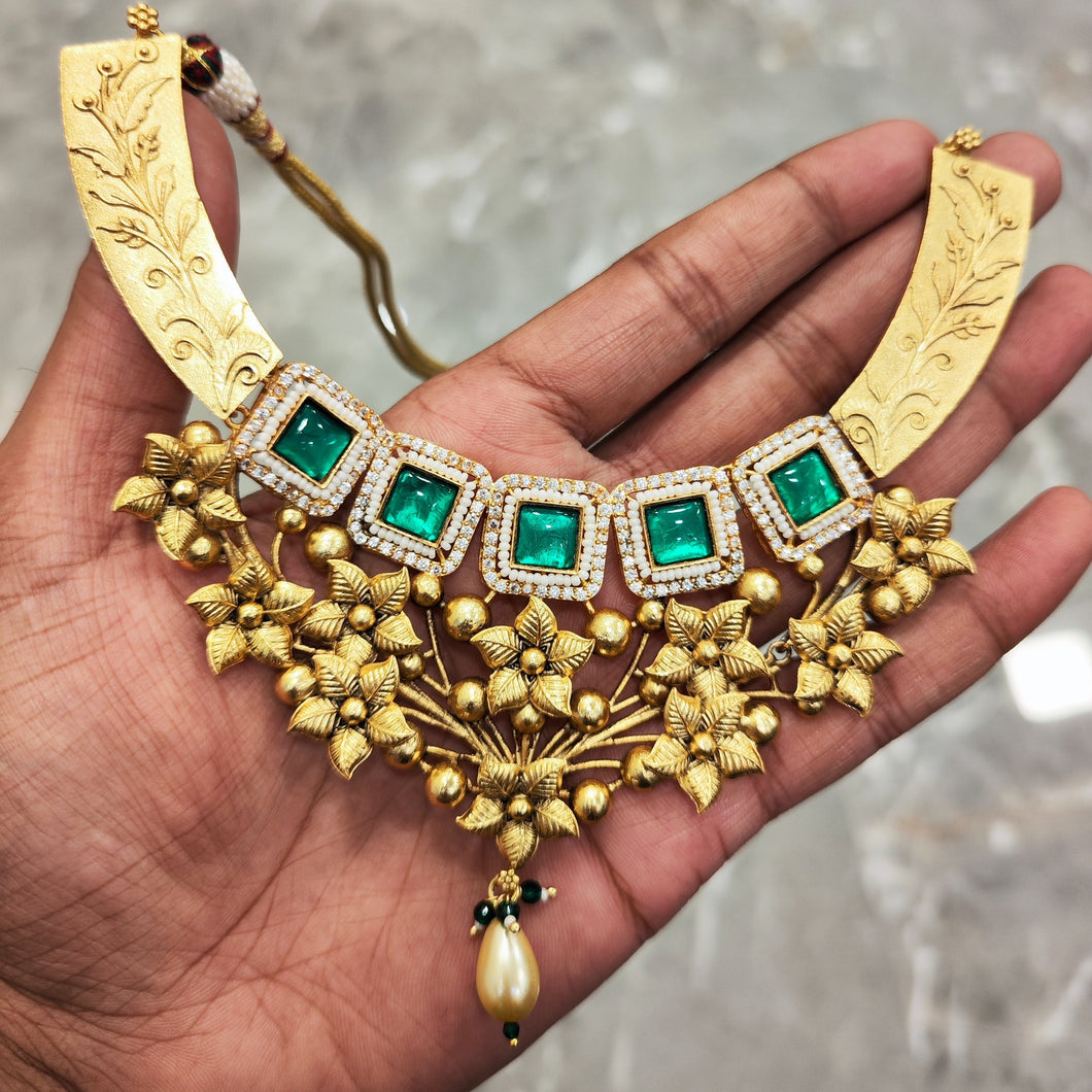 gold necklace set with green stones